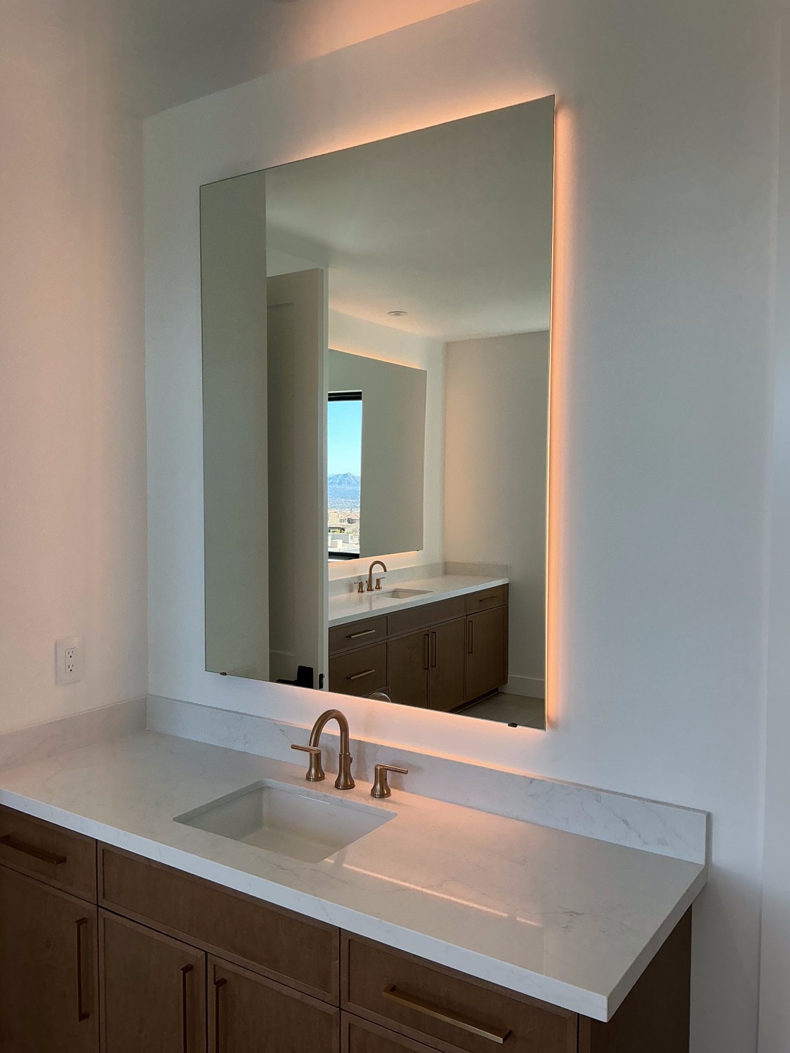 Backlit vanity mirror with mountain view