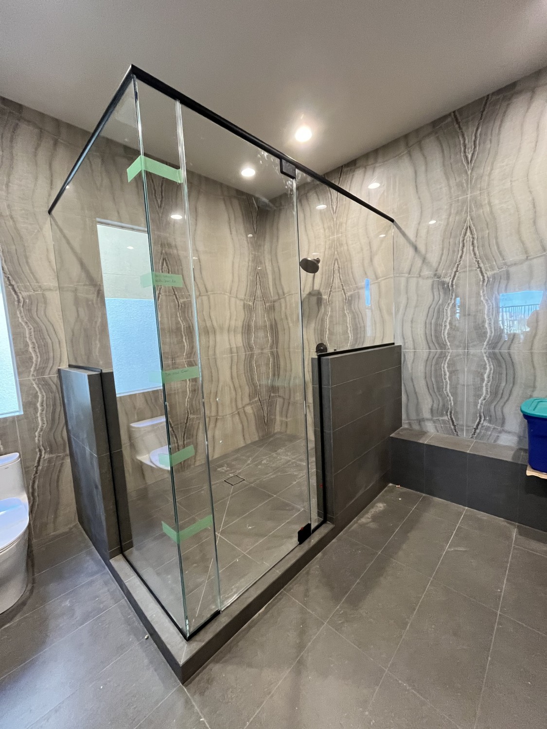 Walk-in shower with rainfall showerhead and glass door