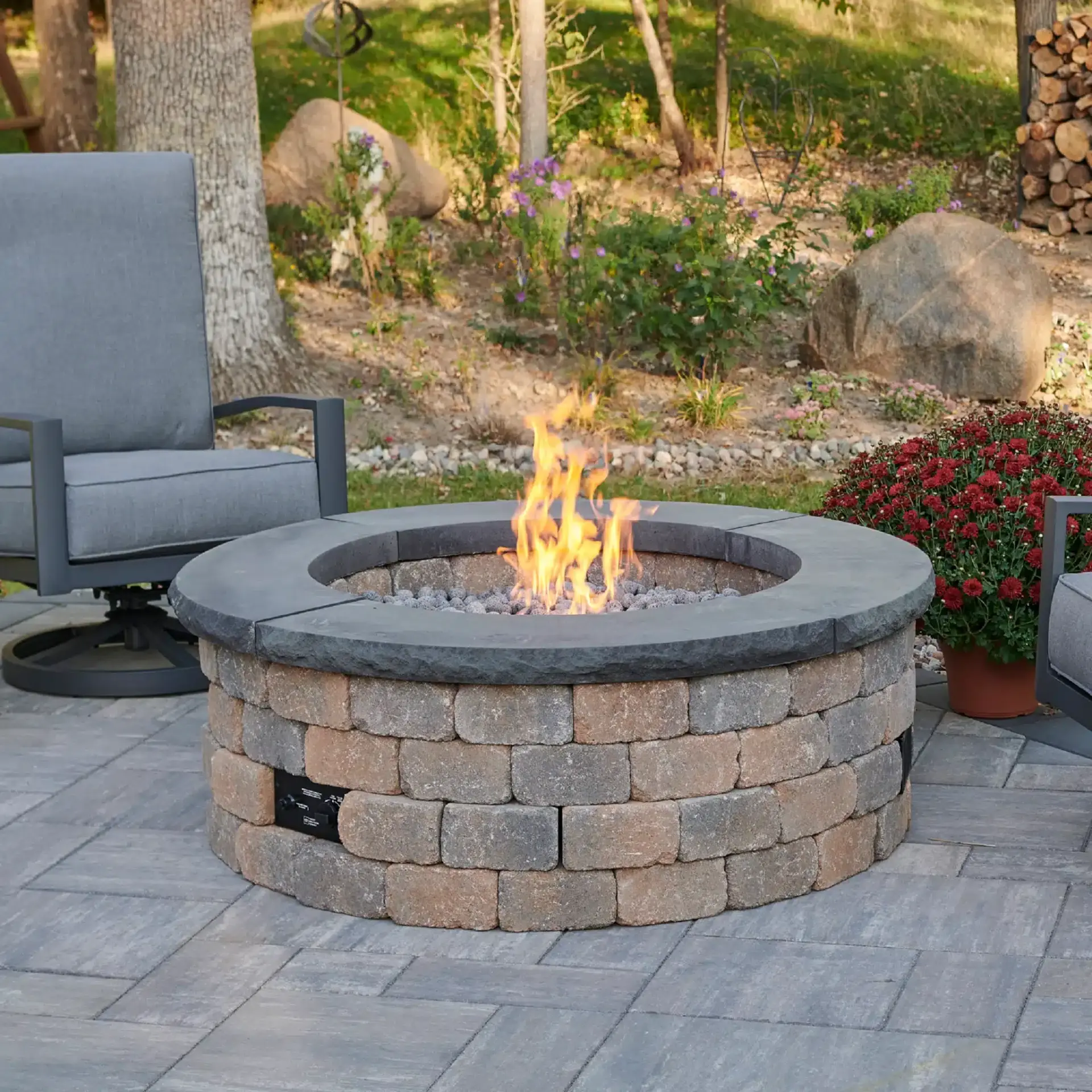 Stone outdoor fireplace with pool view